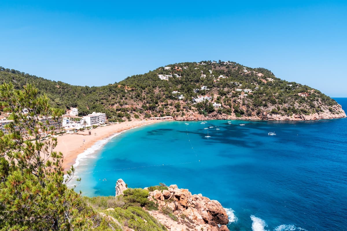 Blue waters and green hills on the shores of Ibiza